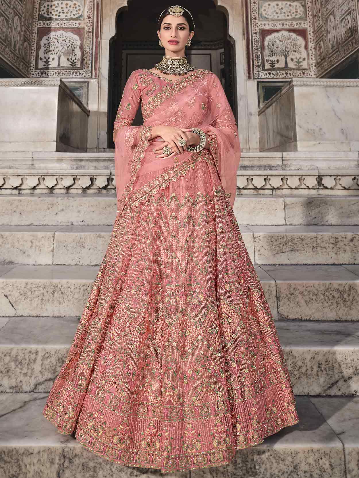 Bridal lehenga paired with peach color heavily embellished choli